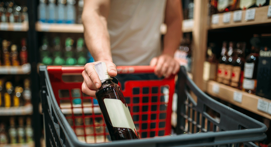 male-person-put-bottle-of-wine-in-a-cart-9BWMCP5